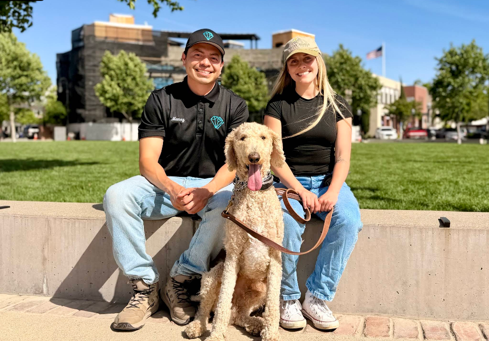Manny and a happy dog with its owner